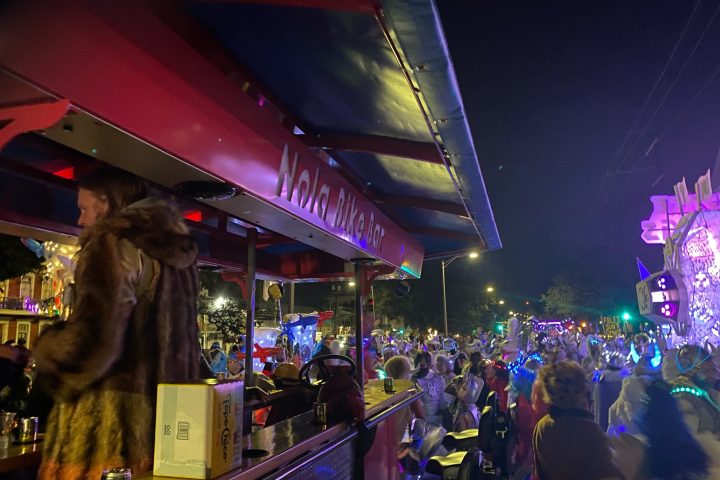 a crowd of people standing on a stage in front of a store