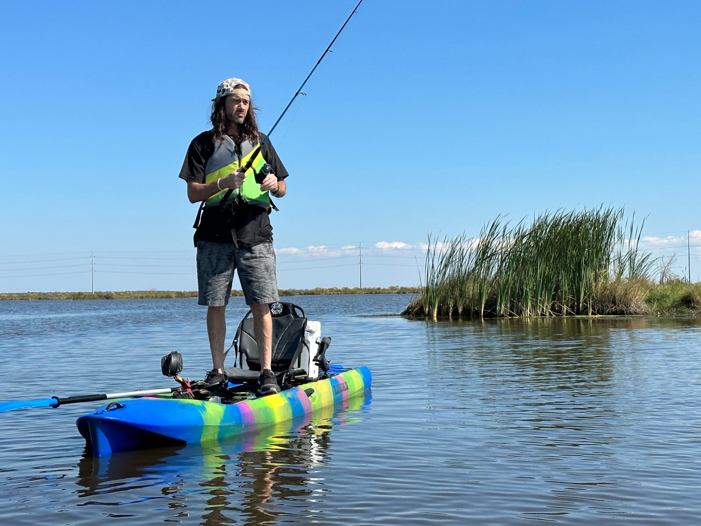 kayak fishing new orleans a man riding on the back of a boat in the water
