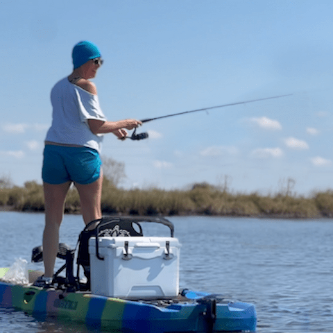a person riding on the back of a boat in the water