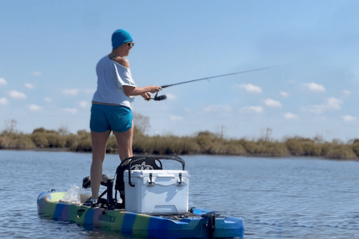 a person riding on the back of a boat in the water